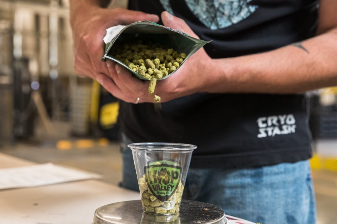  man pouring ingredients on a hop valley cup